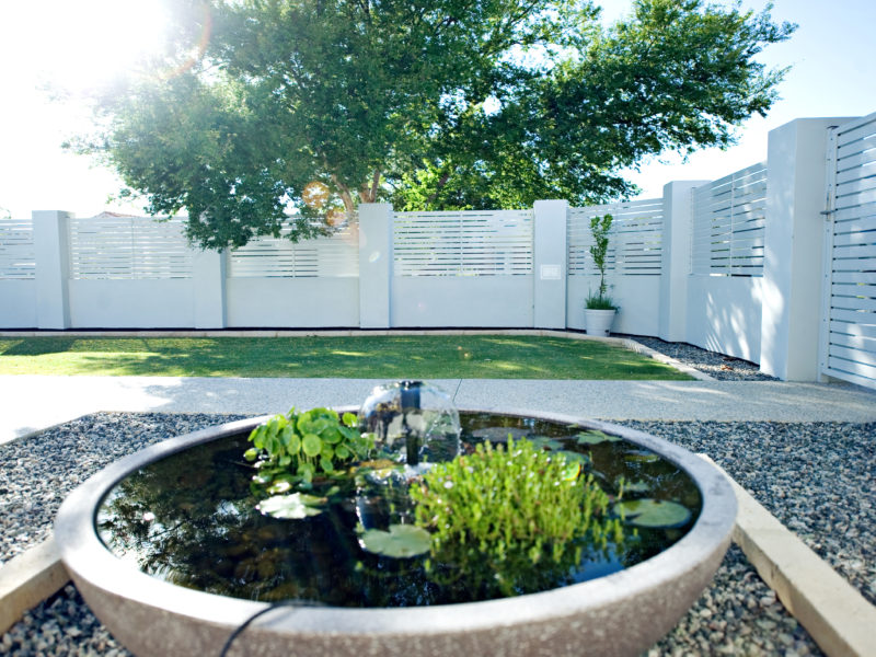 White slat Hamptons Style louvre fencing in courtyard