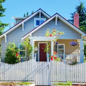 white picket fence surrounding home