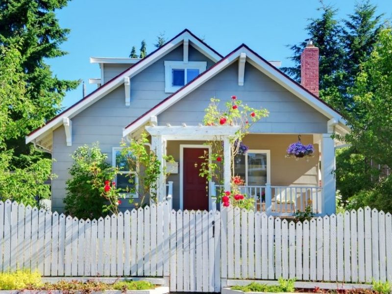 white picket fence surrounding home